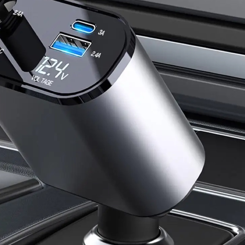 Fourfold Coil 120 in a car's lighter socket, close up on its lit voltage display and its spare USB-C and USB-A ports