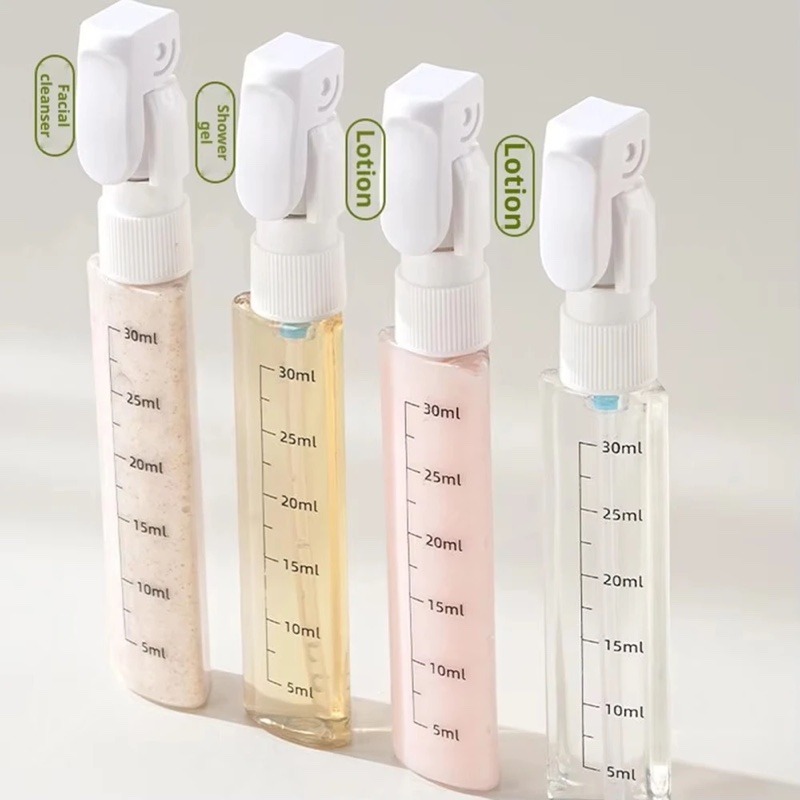 The four Fourfold Decant 4 bottles filled and standing in a row, measuring scales on their sides